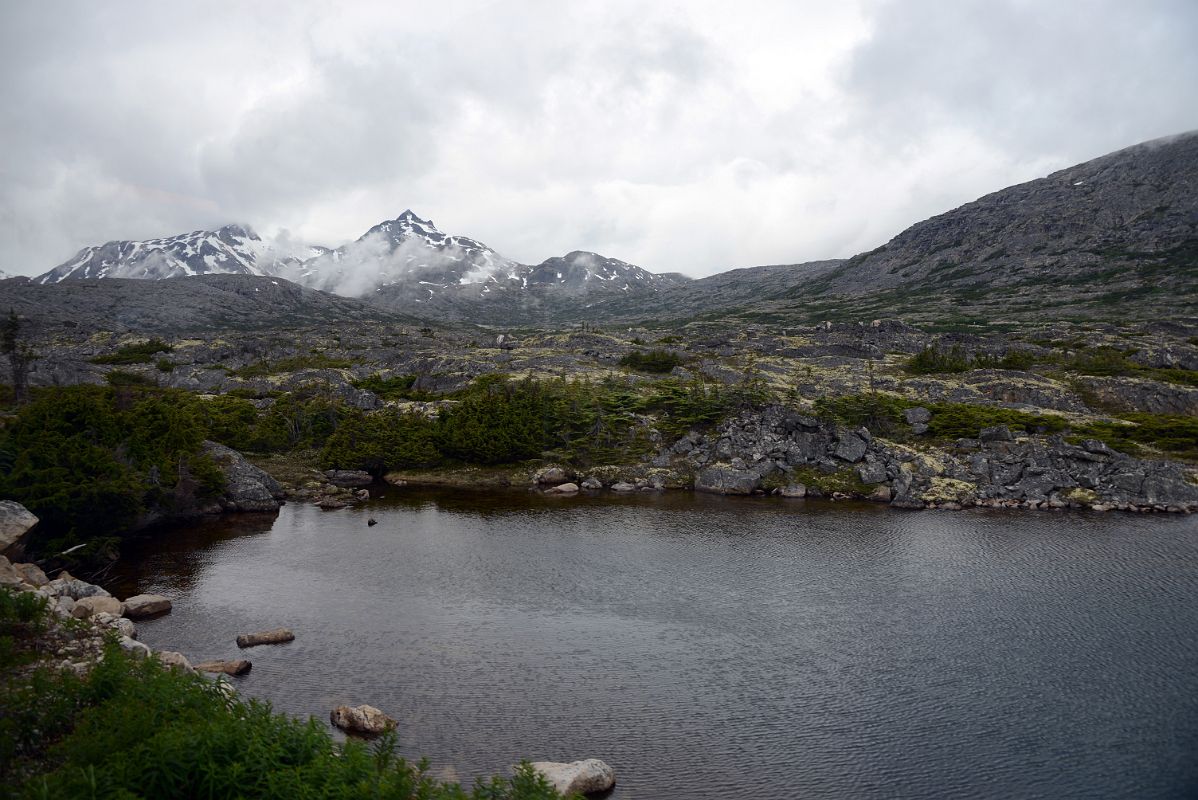 15B Passing A Small Lake With Mountains Beyond From The White Pass and Yukon Route Train Just After leaving Fraser BC On The Tour From Whitehorse Yukon To Skagway
